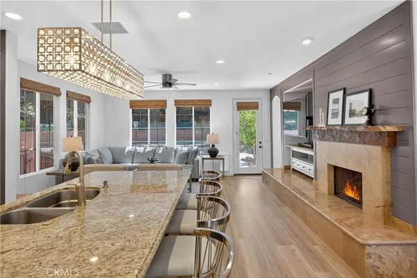 a living room with furniture a large window and a flat screen tv