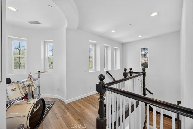 a bedroom with a large bed a flat screen tv and a window