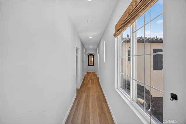a living room with furniture a wooden floor and a sink