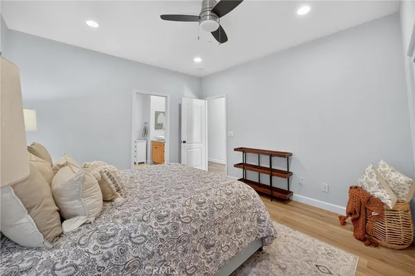 a bedroom with a large bed a flat screen tv and a window