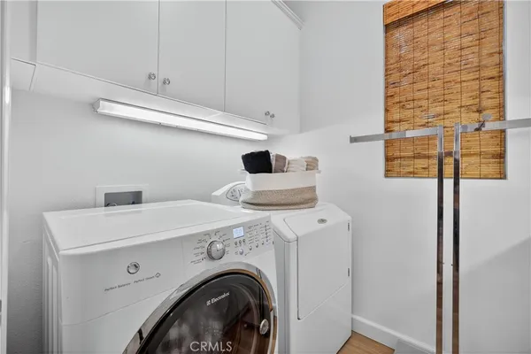 a living room with furniture a wooden floor and a sink
