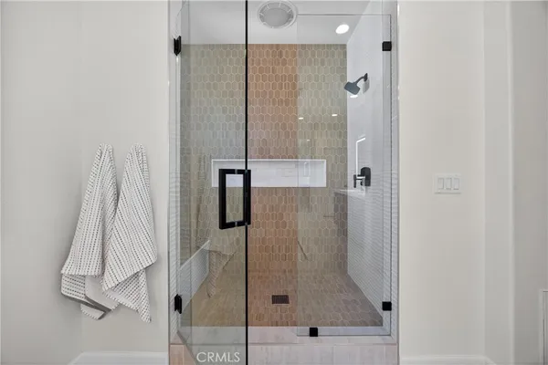 a large kitchen with granite countertop a stove top oven a sink dishwasher and a fireplace with wooden floor