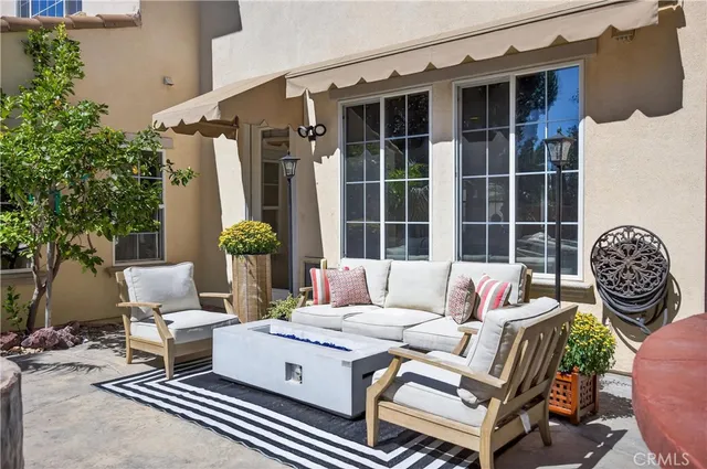 a large kitchen with granite countertop a stove top oven a sink dishwasher and a fireplace with wooden floor