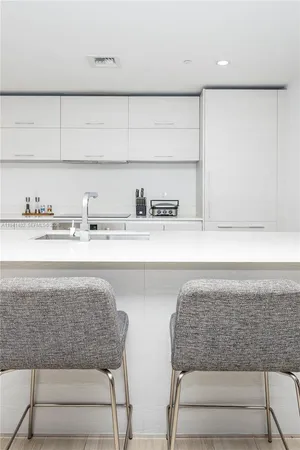 a living room with granite countertop a rug