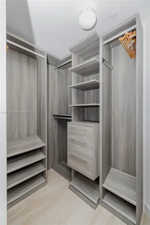 a view of walk in closet with empty racks