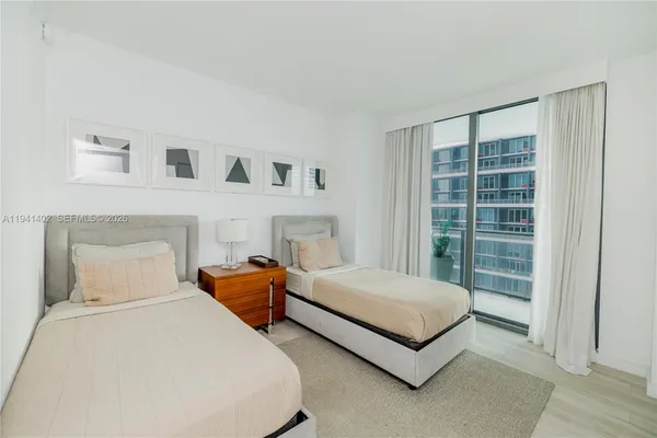 a bedroom with bed and a window