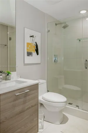 a bathroom with a toilet sink and shower