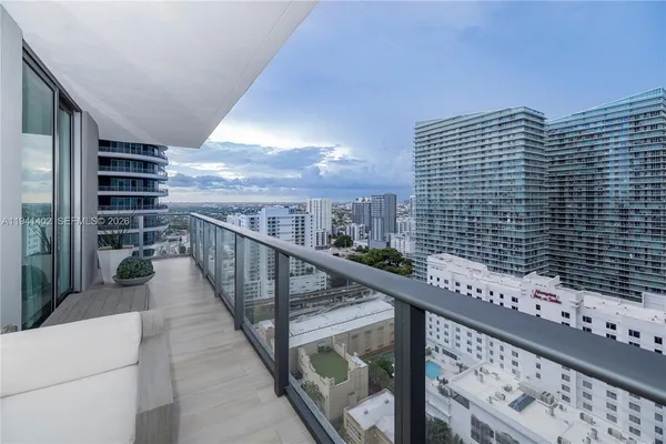 a view of balcony with wooden floor