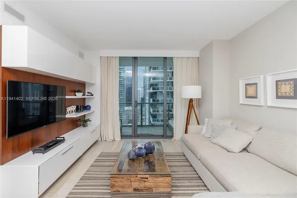 a living room with furniture fireplace and flat screen tv