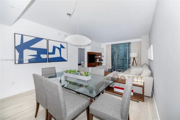 a living room with furniture and a painting on the wall