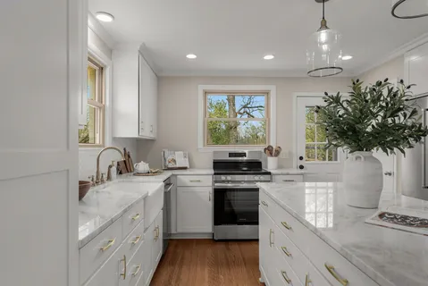 a kitchen with a sink stove and cabinets