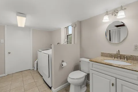 a bathroom with a toilet a sink and mirror