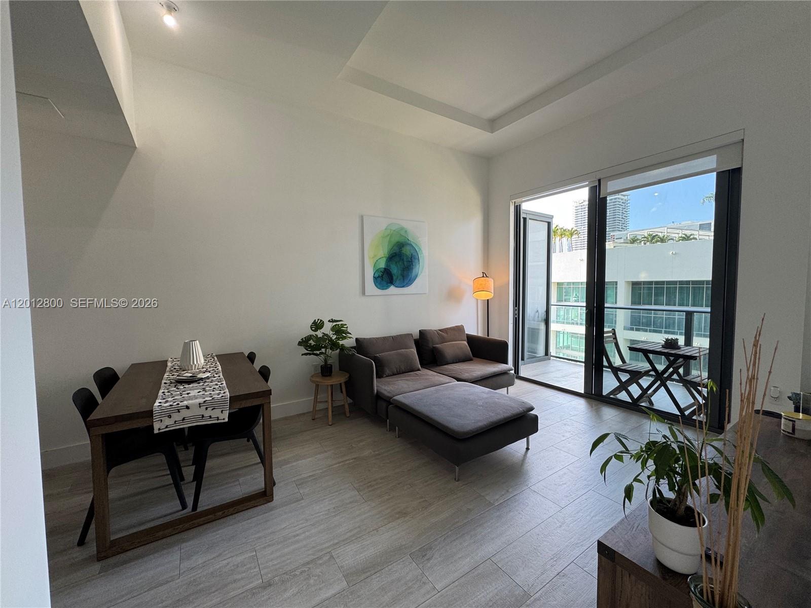 121 Northeast 34th Street, Unit L601 Miami, FL 33137 - Photo 2 of 32 a living room with furniture and a large window