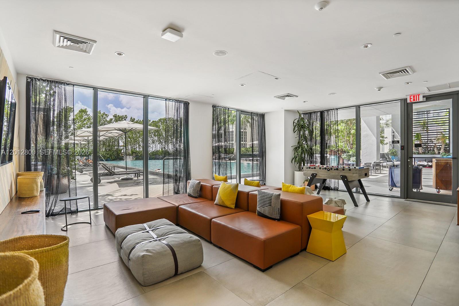 121 Northeast 34th Street, Unit L601 Miami, FL 33137 - Photo 21 of 32 a living room with furniture and floor to ceiling windows