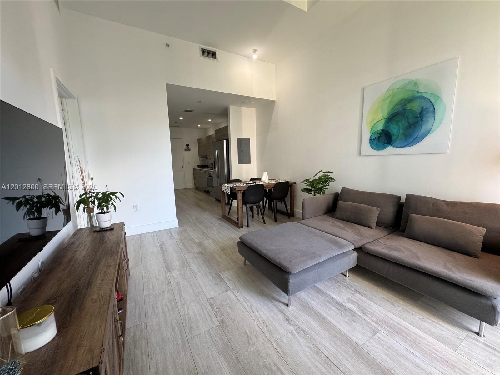 121 Northeast 34th Street, Unit L601 Miami, FL 33137 - Photo 5 of 32 a living room with furniture and wooden floor