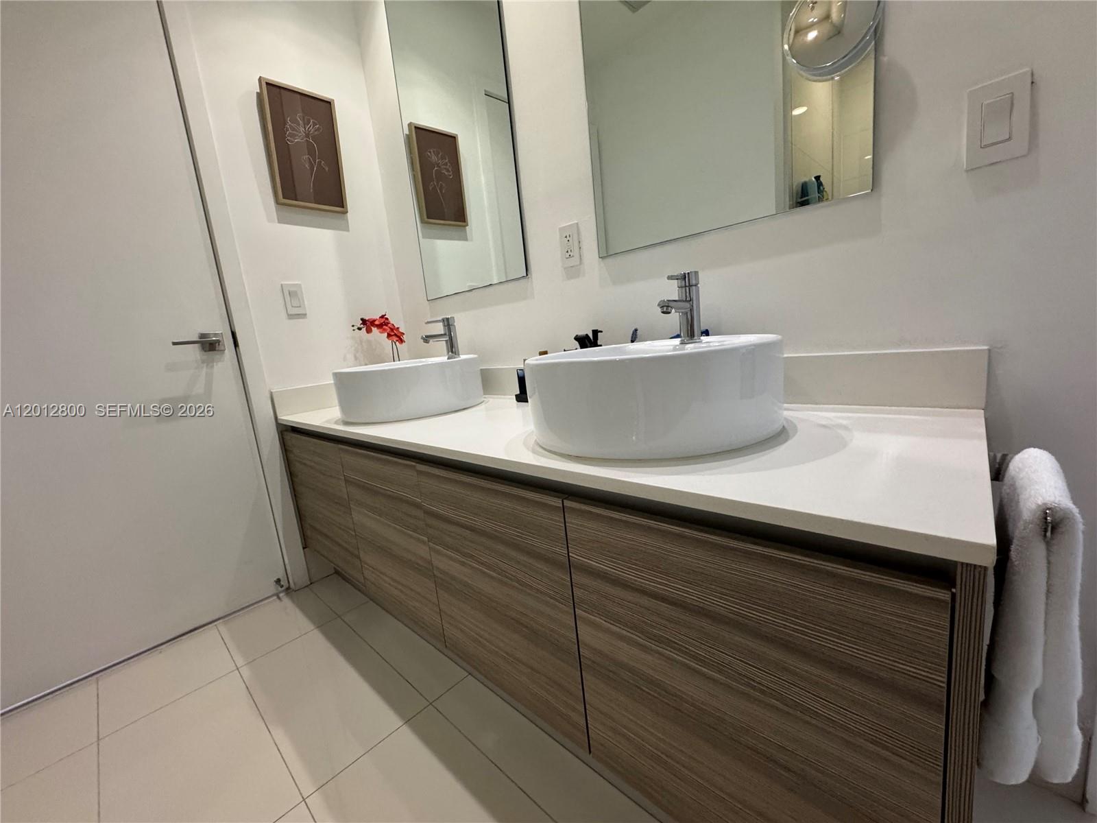 121 Northeast 34th Street, Unit L601 Miami, FL 33137 - Photo 10 of 32 a bathroom with a sink and a mirror