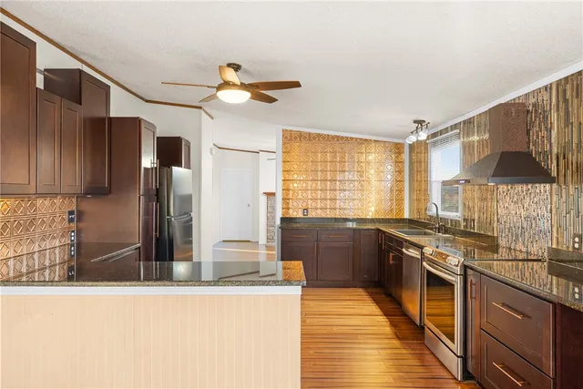 a kitchen with stainless steel appliances granite countertop a stove and a sink
