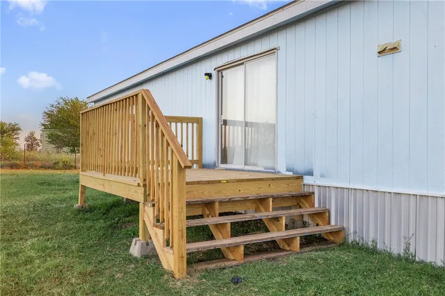 a view of backyard with deck and garden