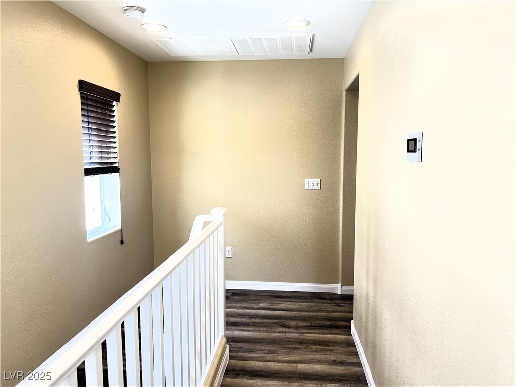 9535 Leaping Lizard Street Las Vegas, NV 89178 - Photo 29 of 37 Hallway leading out from Primary bedroom, secondary bedrooms, bathroom and laundry room are off to the right.