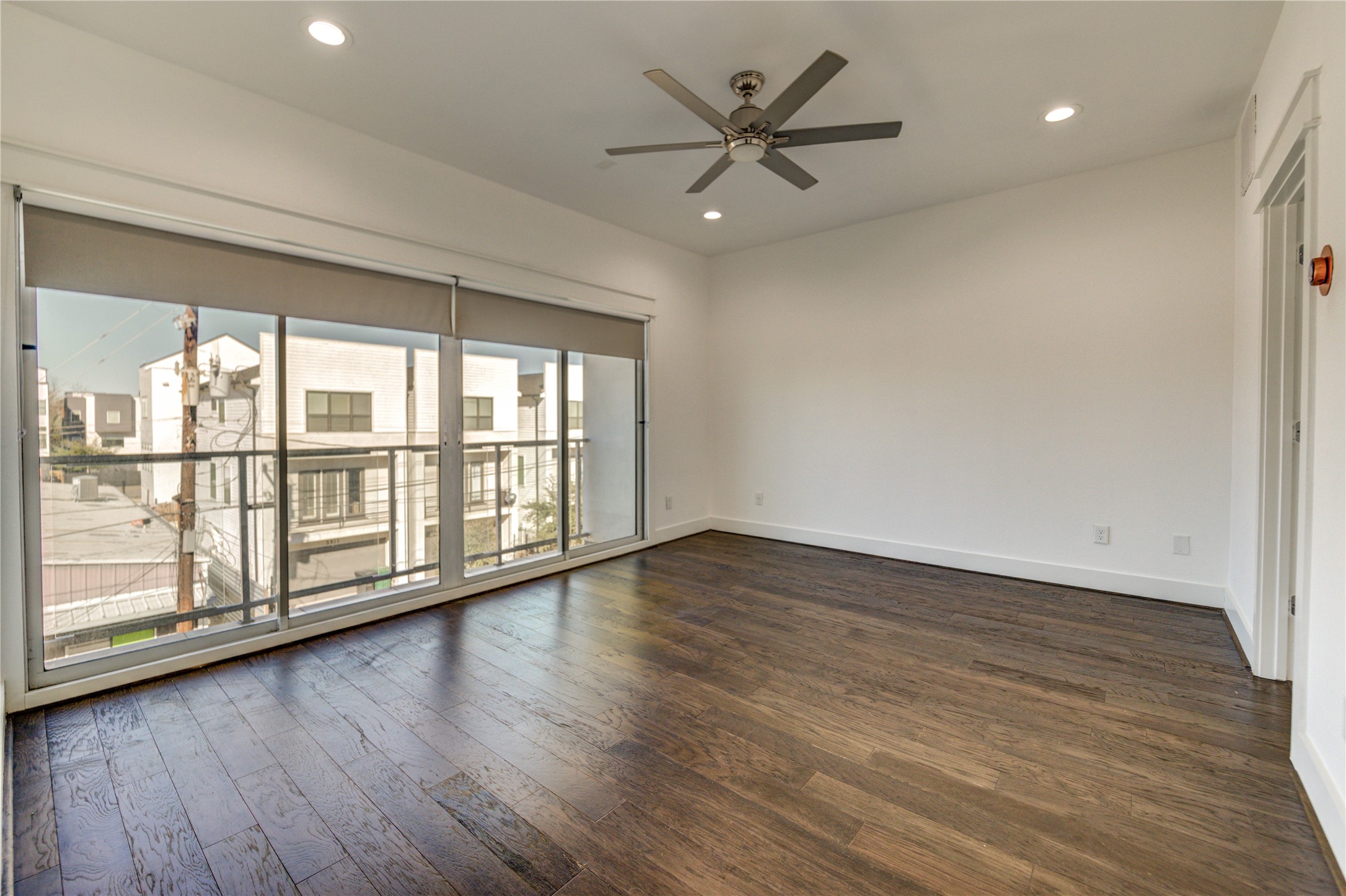 3306 Cline Street Houston, TX 77020 - Photo 14 of 30 a view of an empty room with wooden floor and a window