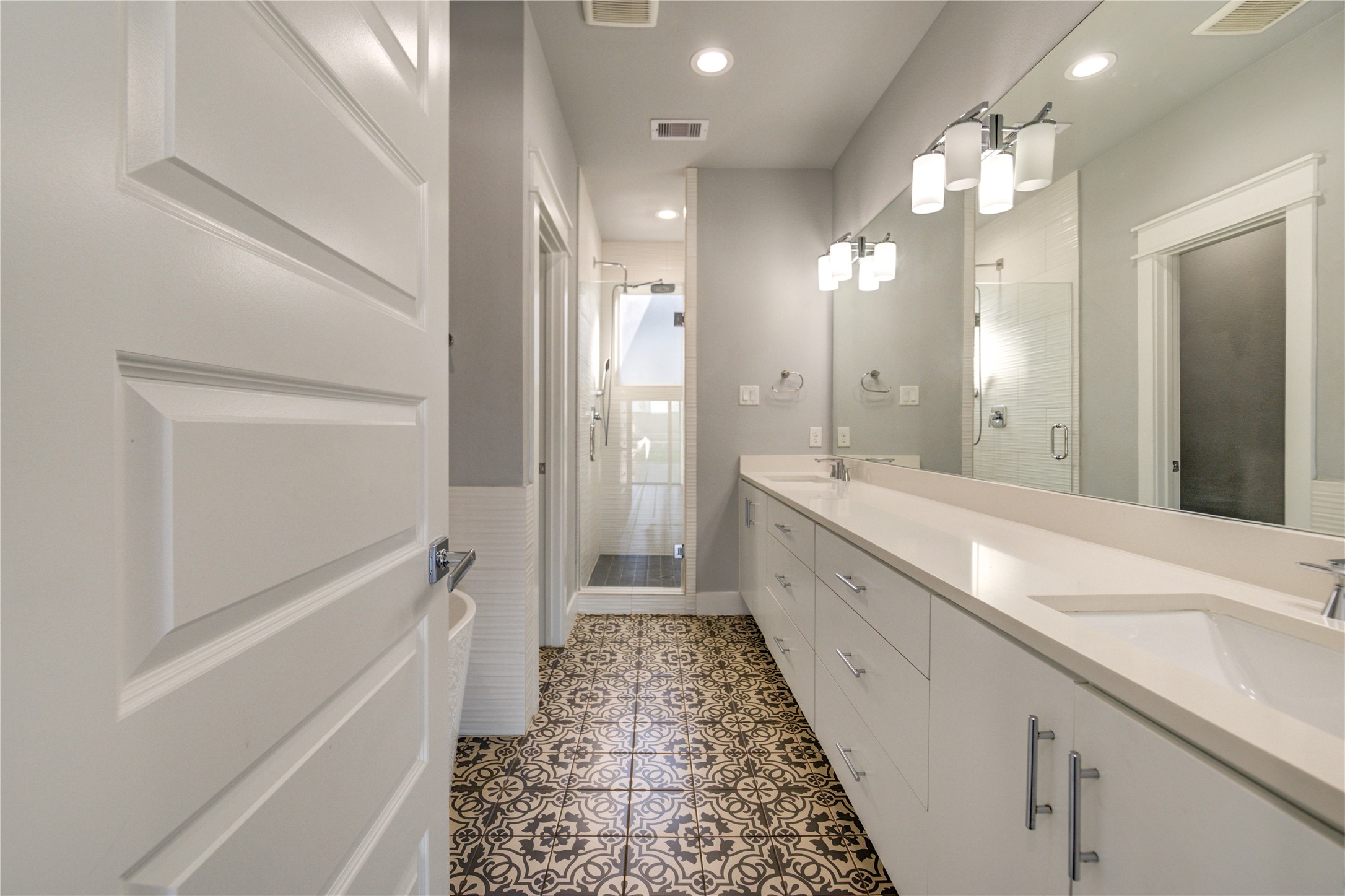 3306 Cline Street Houston, TX 77020 - Photo 17 of 30 a large white bathroom with a granite countertop sink a toilet a mirror and shower