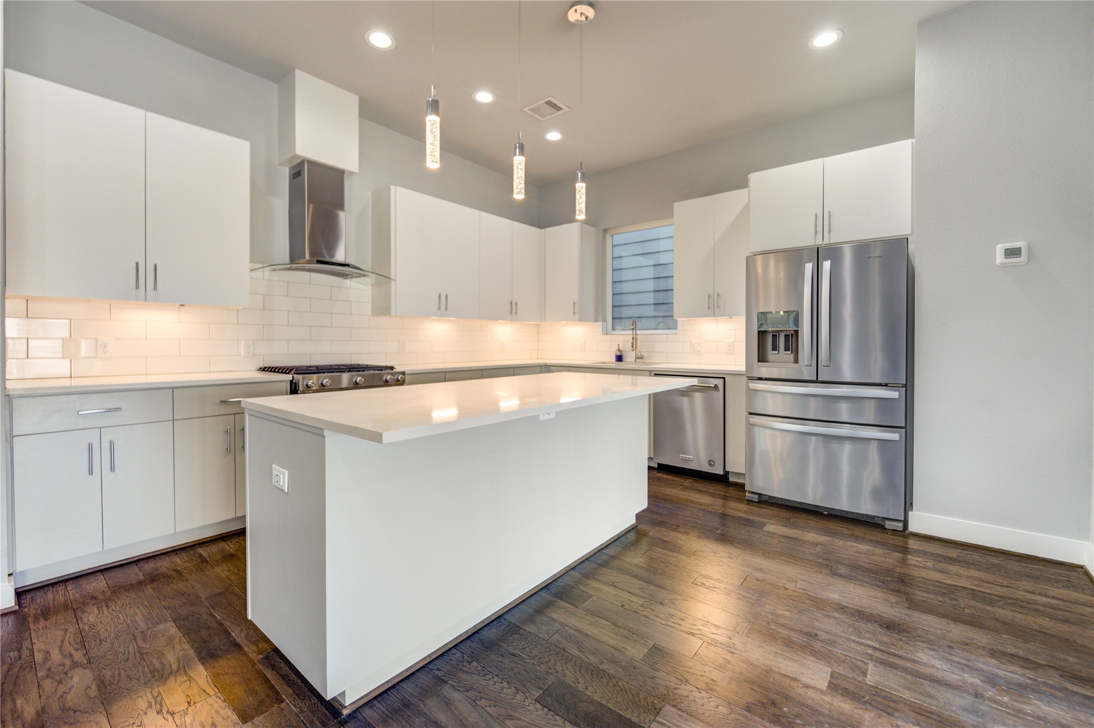 3306 Cline Street Houston, TX 77020 - Photo 2 of 30 a kitchen with kitchen island white cabinets and stainless steel appliances