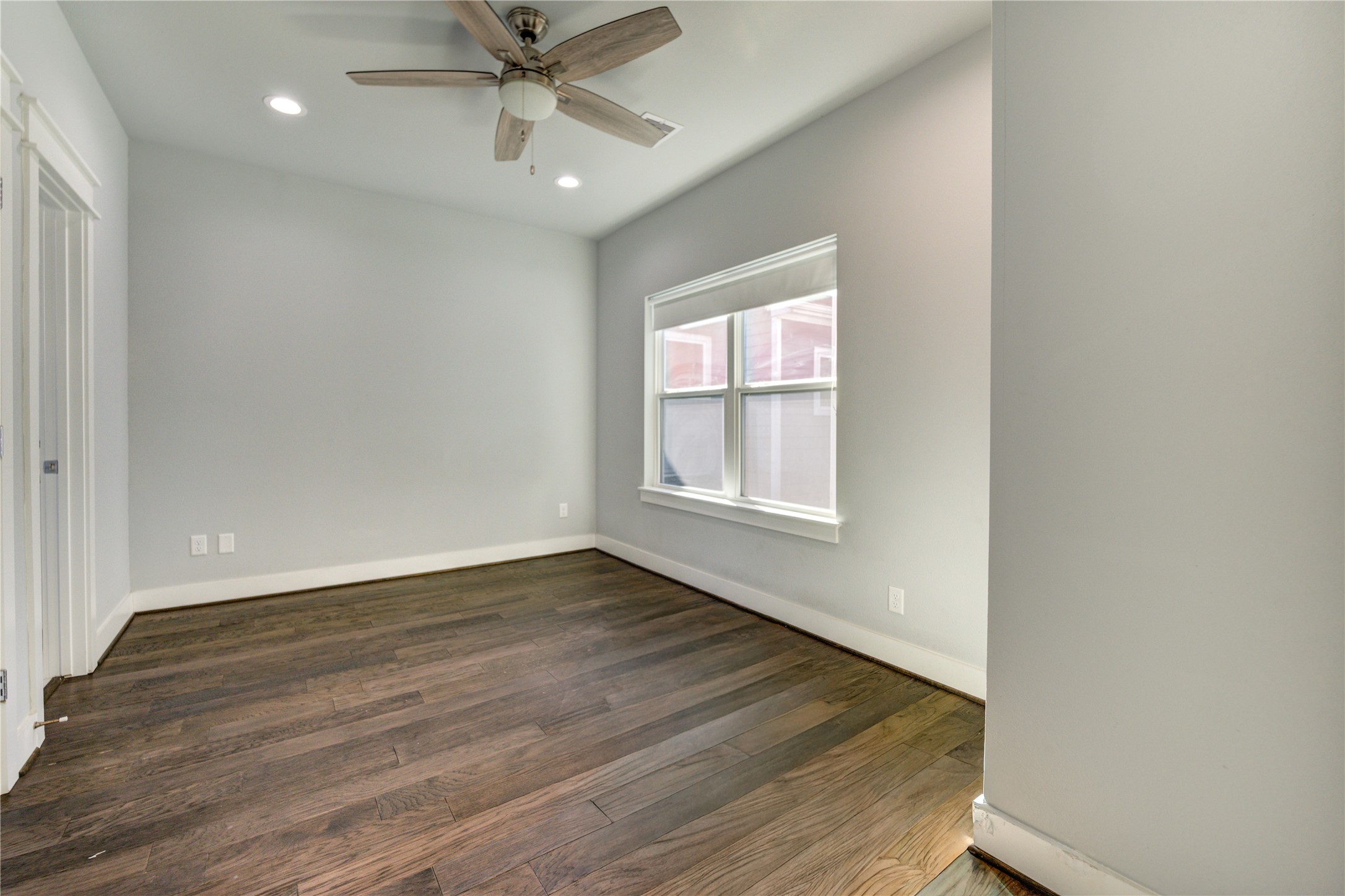3306 Cline Street Houston, TX 77020 - Photo 23 of 30 an empty room with wooden floor fan and windows