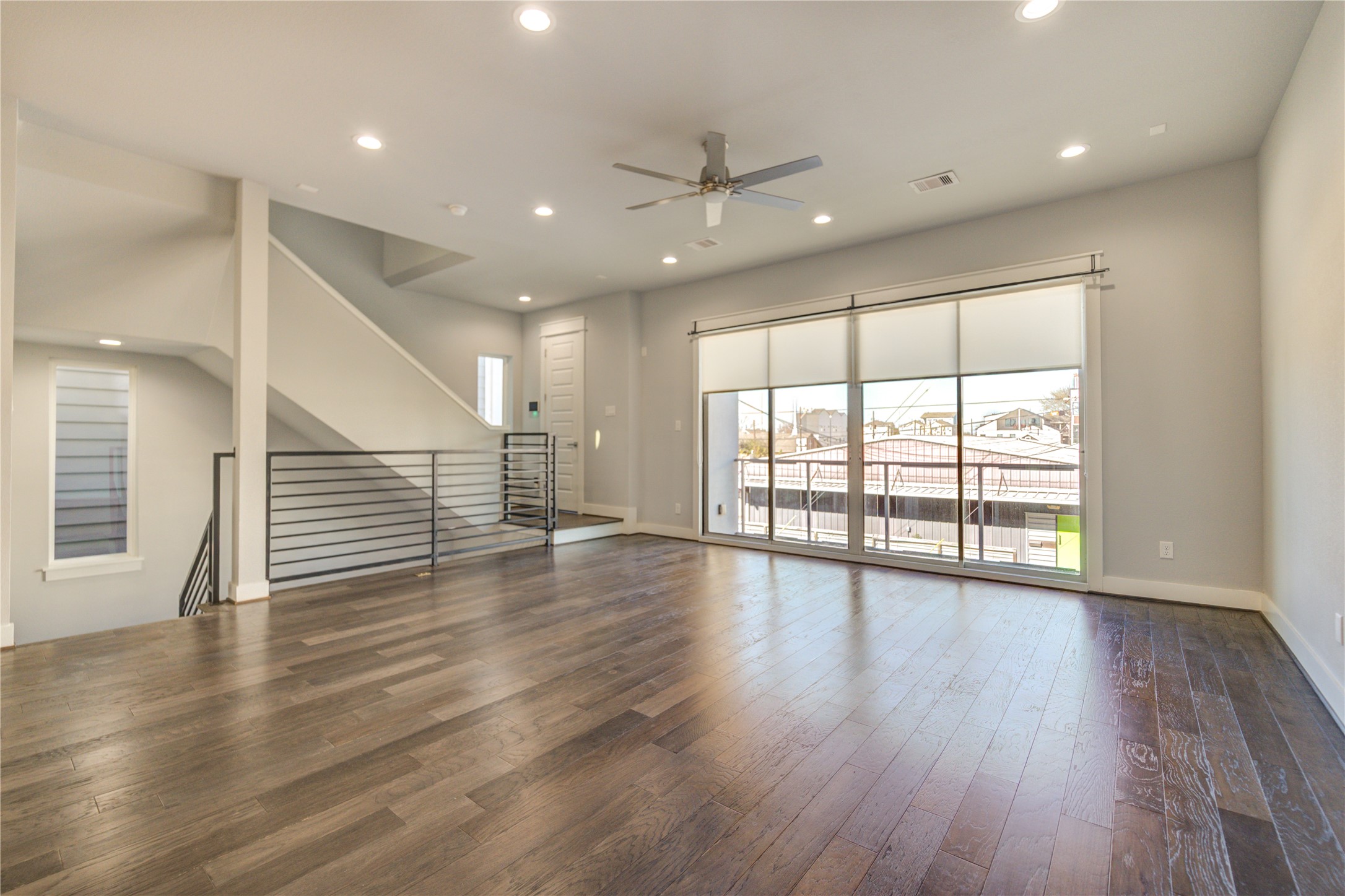 3306 Cline Street Houston, TX 77020 - Photo 5 of 30 a view of an empty room with wooden floor and a window