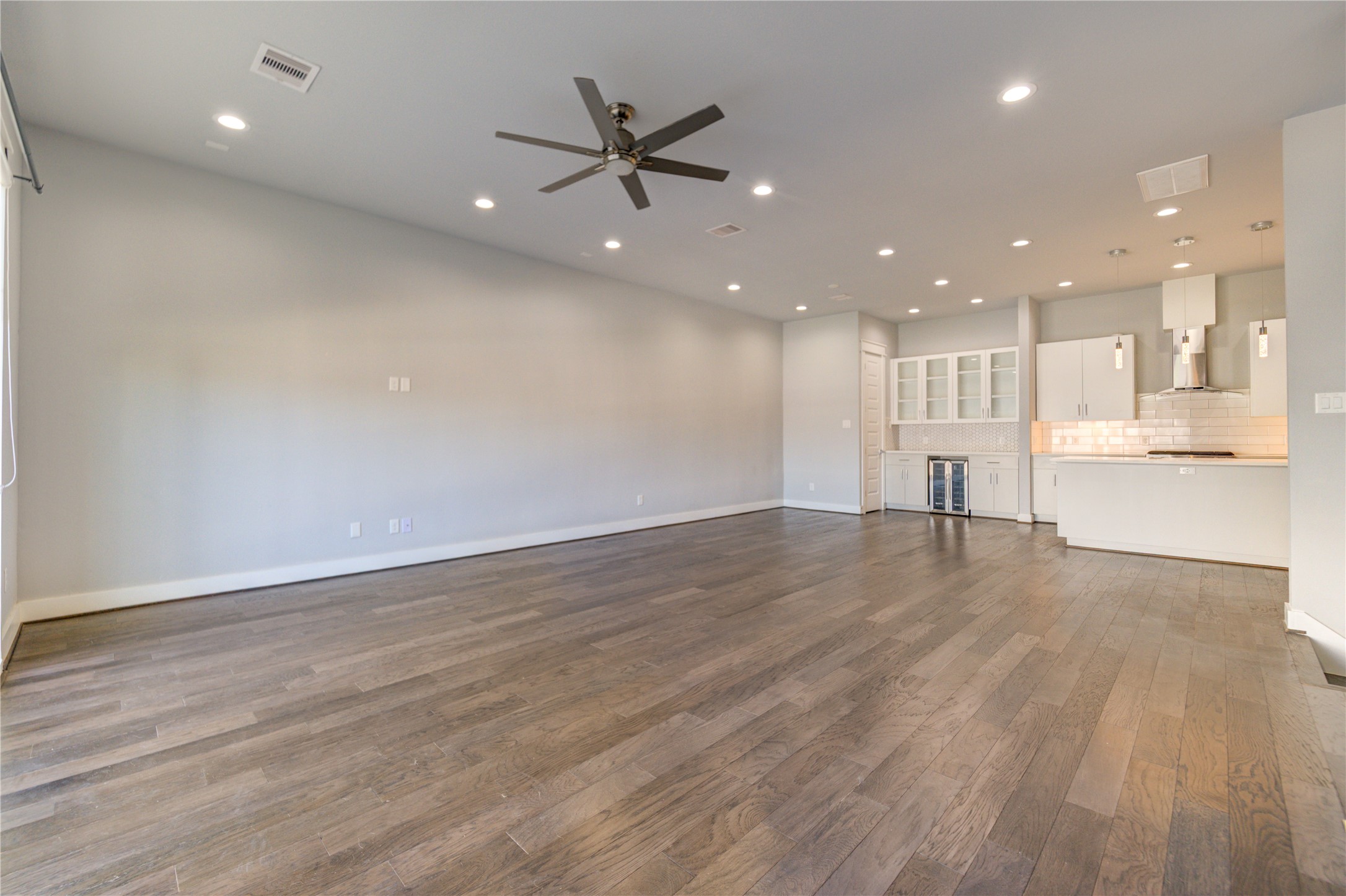 3306 Cline Street Houston, TX 77020 - Photo 7 of 30 an empty room with wooden floor and windows