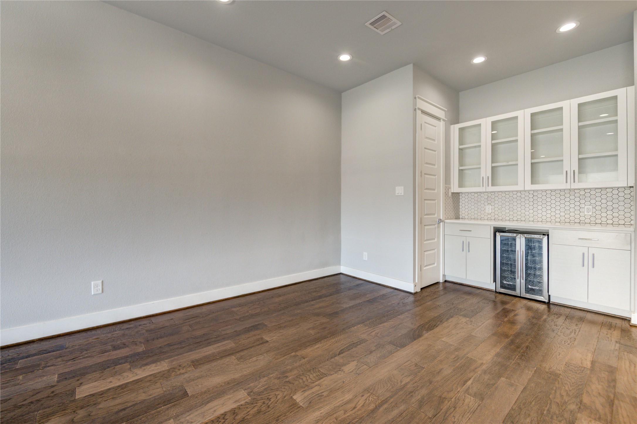 3306 Cline Street Houston, TX 77020 - Photo 9 of 30 a view of an empty room with wooden floor and a window