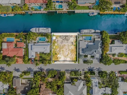 an aerial view of a house with a lake view