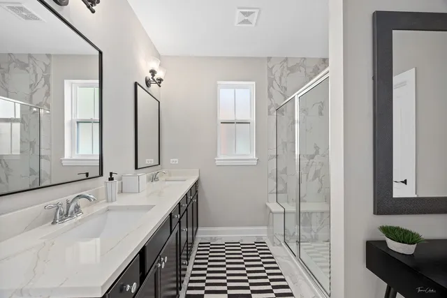 a bathroom with a double vanity sink and a mirror