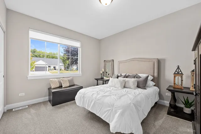 a bedroom with a bed and a large window