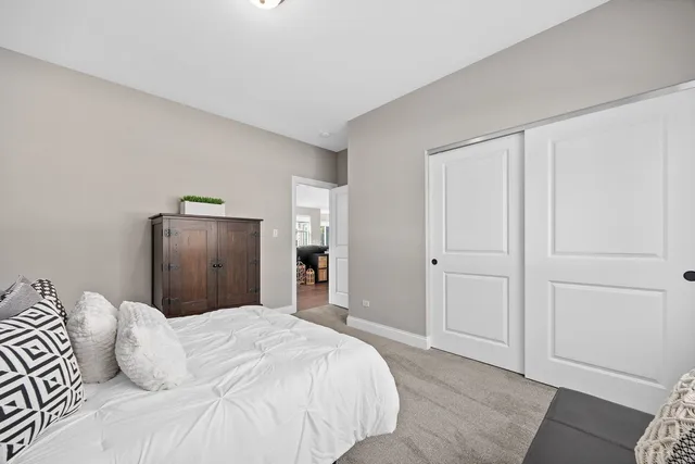 a bedroom with a bed and mirror