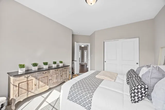 a bedroom with furniture and wooden floor
