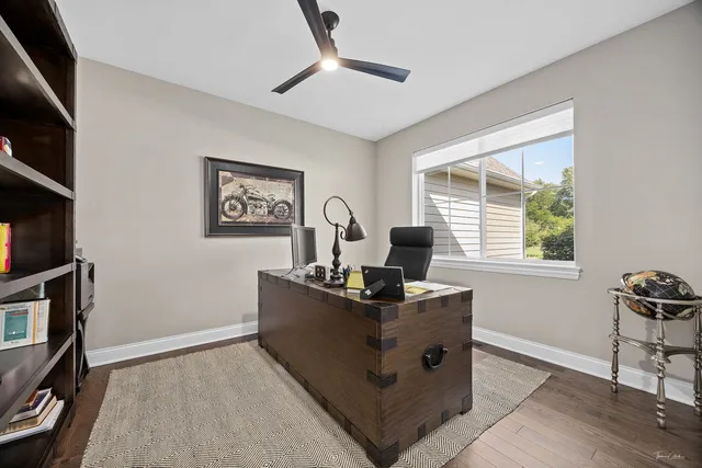 a view of a workspace with furniture and a window