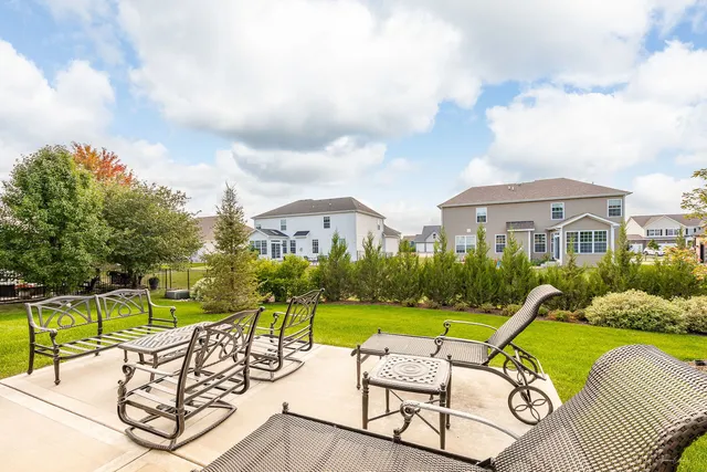 a view of a house with swimming pool and porch with furniture