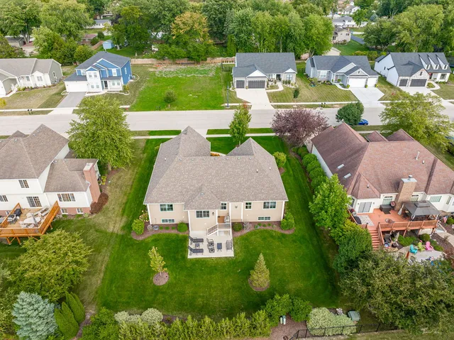 an aerial view of residential houses with outdoor space and parking