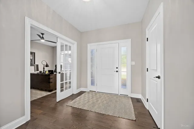 a view of a hallway view with wooden floor and furniture