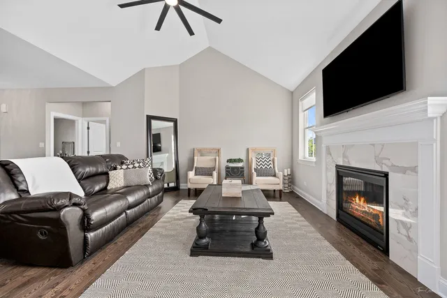 a living room with furniture a flat screen tv and a fireplace
