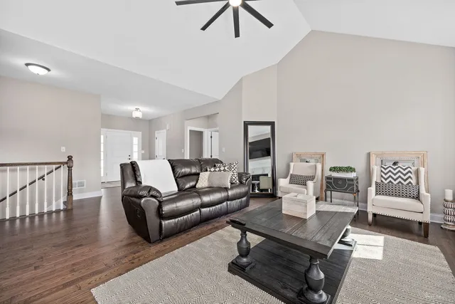 a living room with furniture a wooden floor and chandelier
