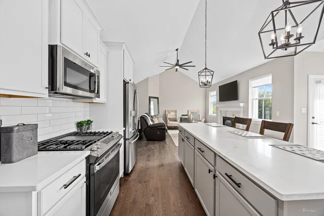 a kitchen with stainless steel appliances a stove sink microwave and cabinets