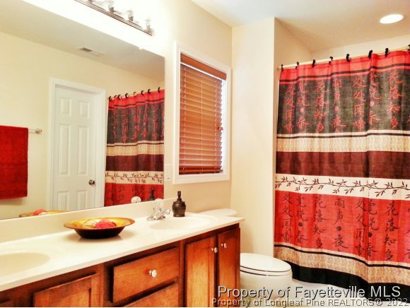 75 Holly Oak Circle Bunnlevel, NC 28323 - Photo 13 of 25 a bathroom with a sink and a toilet