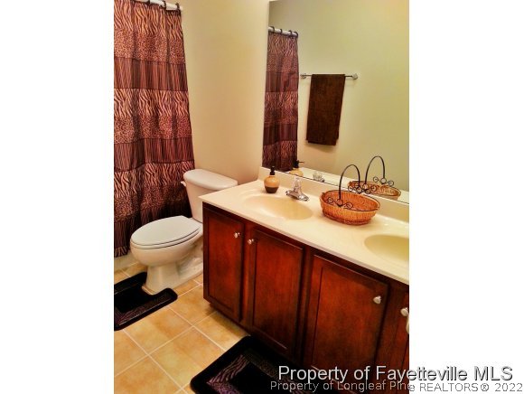 75 Holly Oak Circle Bunnlevel, NC 28323 - Photo 17 of 25 a bathroom with a sink and a mirror