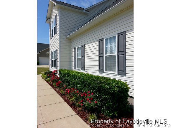 75 Holly Oak Circle Bunnlevel, NC 28323 - Photo 23 of 25 a potted plant sitting in front of a house