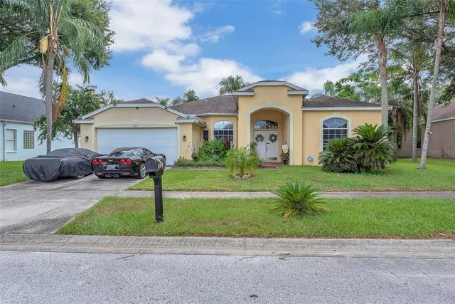 a front view of house with yard and green space