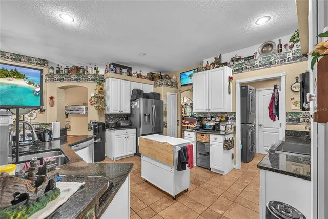 a kitchen with refrigerator and stove
