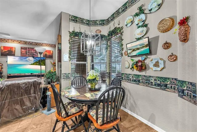 a view of a dining room with furniture and a flat screen tv