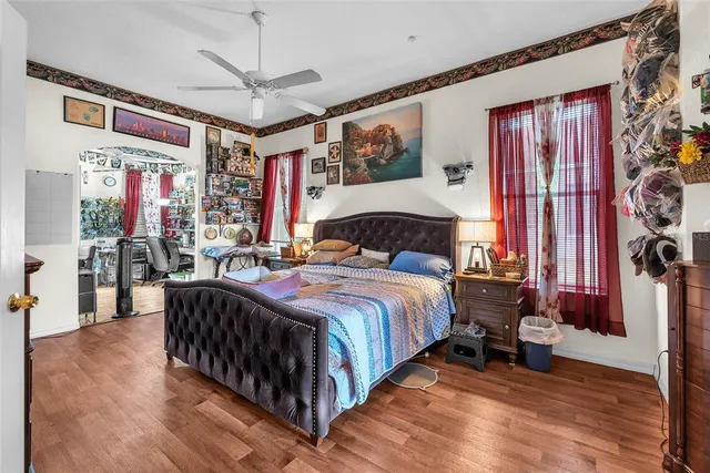 a bedroom with a bed a closet and a large mirror