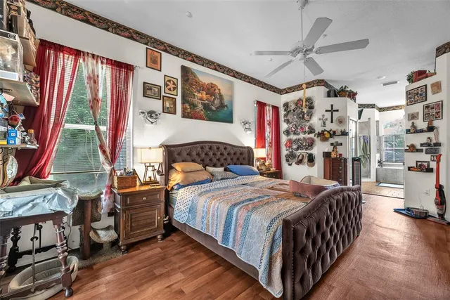 a bedroom with a bed and a chandelier